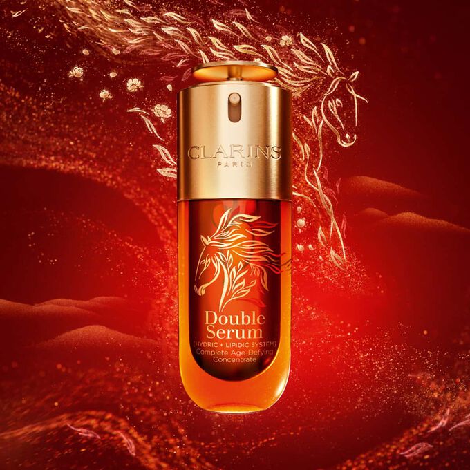 Packshot of Clarins Double Serum Chinese New Year Limited Edition on a red background with a golden horse.