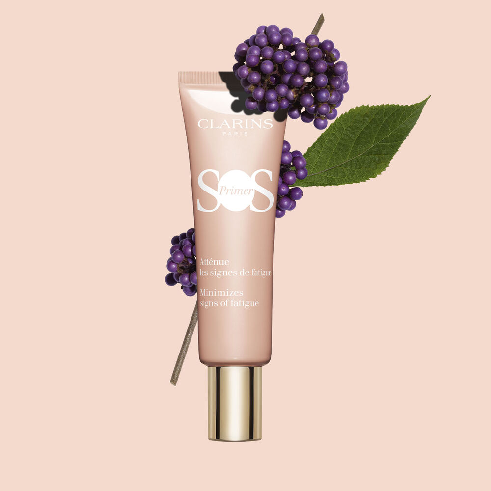 Packshot of a tube of SOS Primer Pink by Clarins, featuring beautyberries, to minimise fatigue and boost radiance.