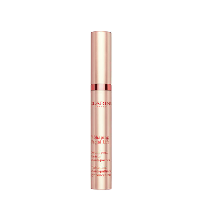 Packshot of a tube of the V Shaping Facial Lift Eye by Clarins close to irish moss on a light pink background.