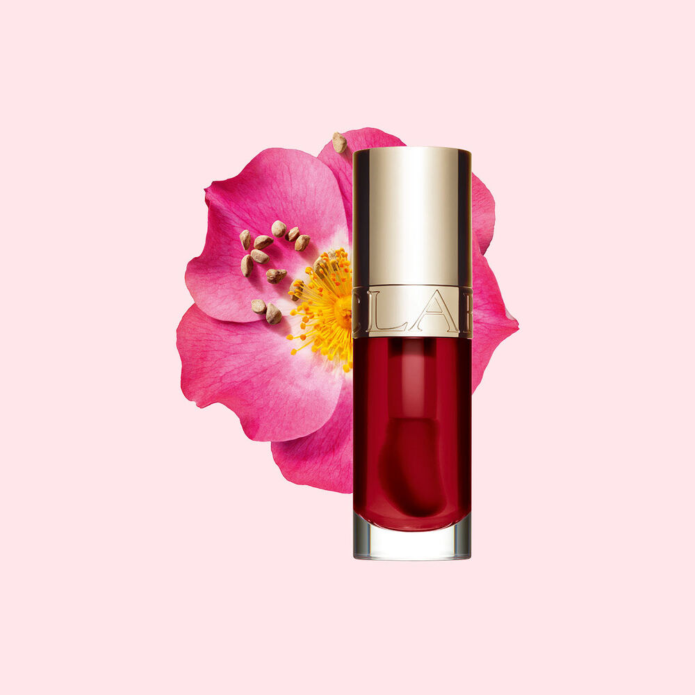 Clarins Lip Comfort Oil 03 Cherry with skincare benefits, in front of a Sweetbriar rose to highlight its natural ingredients.