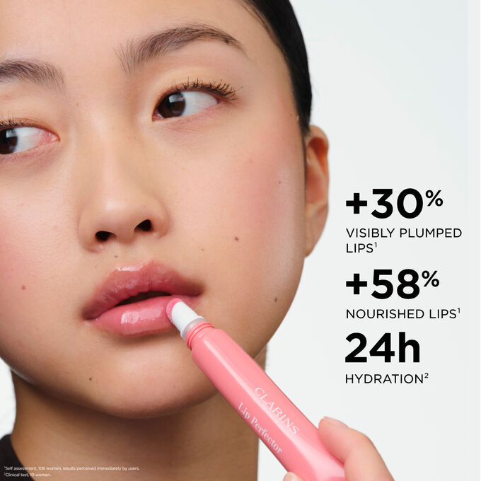 Woman applying Plumping Lip Perfector, highlighting  plumped lips and nourished lips effect, and 24h hydration benefits.