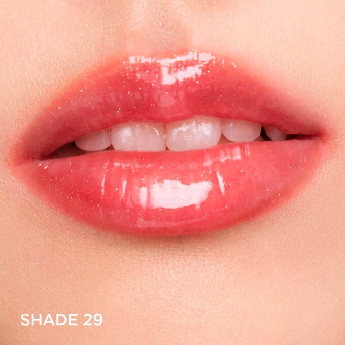 Close-up of lips wearing Clarins Lip Comfort Oil - Limited Edition in Nude shimmery shade, hydrating, plumping, and glossy.