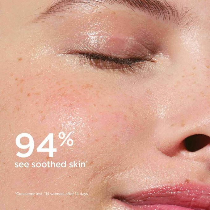 Focus on the lotion application on a woman's cheek to illustrated that 94% of testers find their skin soothed